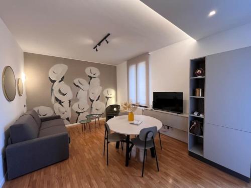 a living room with a couch and a table at Apartment Aurora Rho Fiera in Milan