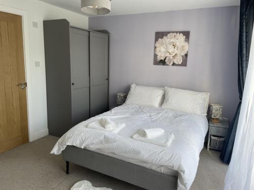 a bedroom with a bed with towels on it at Porthkidney Suite, Carbis Bay, St Ives, free parking, near beach in Carbis Bay