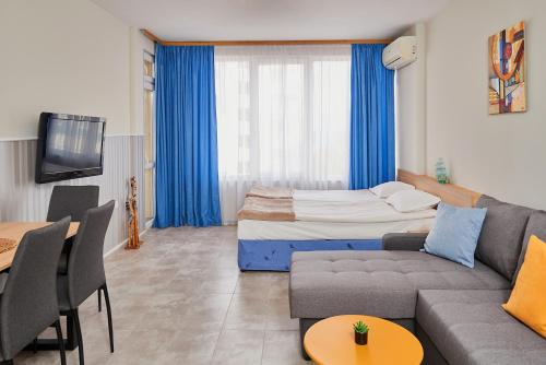 a living room with a couch and a bed at Студио Калина in Pomorie