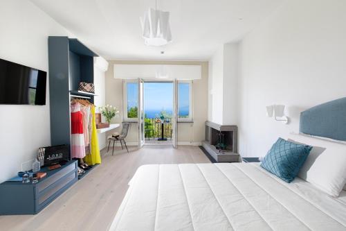 a bedroom with a large bed and a television at AMORE RENTALS - Villa Tittina in Sorrento