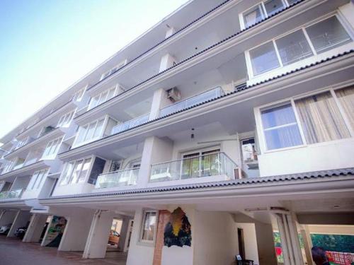 a large white building with a lot of windows at Beachside Bliss Apartment in Colva Salcette- Goa in Colva