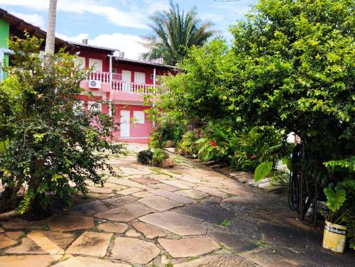 a stone path in front of a house with trees at Pouso da Lapa in Pirenópolis