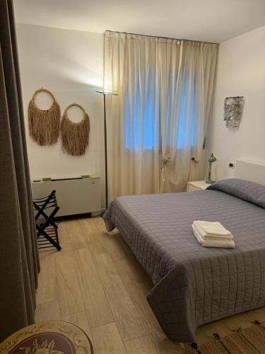 a bedroom with a bed and two mirrors on the wall at Casa D'Angelo in Vicenza