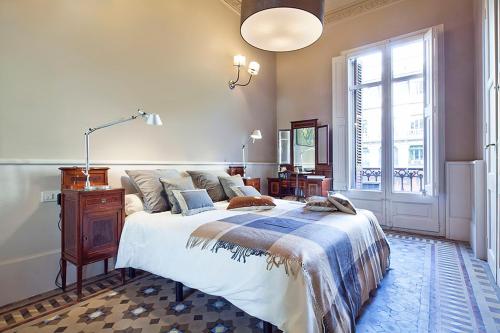 a bedroom with a large bed and a window at Barcino Inversions - Apartments in Rambla de Catalunya in Barcelona