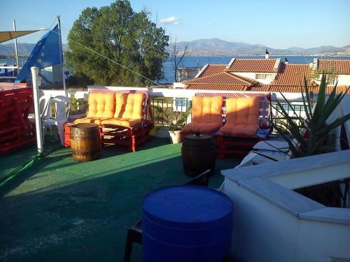 a patio with two chairs and a view of the water at Argoliki Thalassa in Míloi