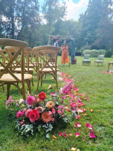 a group of chairs and flowers in a park at Hotel de la Gaichel in Eischen