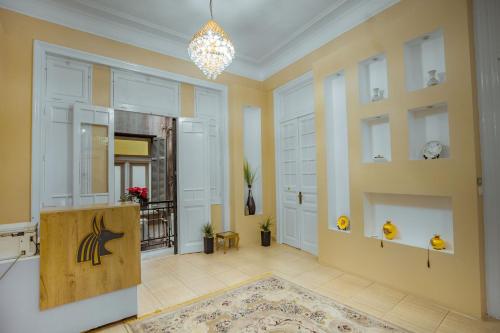 a large room with yellow walls and a chandelier at The Square Boutique Hotel in Cairo