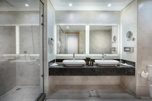 a bathroom with two sinks and a shower at The V Luxury Resort Sahl Hasheesh in Hurghada