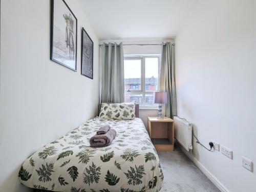 a small bedroom with a bed and a window at Guest Rooms Near City Centre & Dock Free Parking in Liverpool