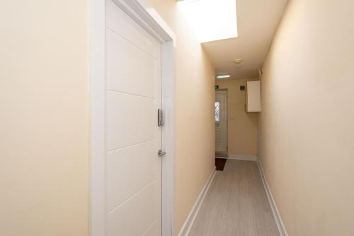 a hallway with a white door in a room at Saffron Studios in Orpington