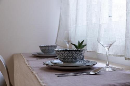 a table with two plates and a wine glass at Micro Studio 84 in Xanthi