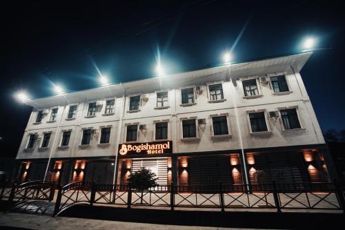 a large white building with a sign on it at Bog’ishamol Hotel Urgut in Min-Bulak