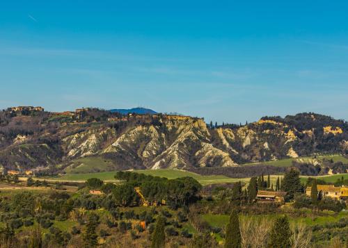 a view of a mountain range with houses and trees at Borgo Il Poggio Agriturismo in Montaione
