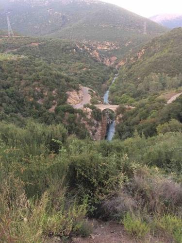 a view of a mountain with a road and a river at Theisoa.Old Little house in the garden . Andritsaina. in Andritsaina