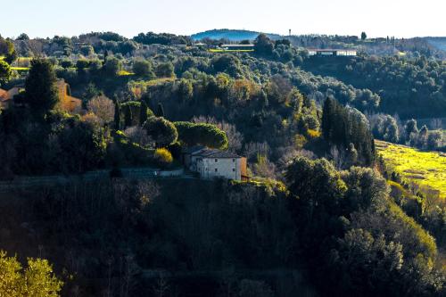 an old house on a hill in a forest at Borgo Il Poggio Agriturismo in Montaione
