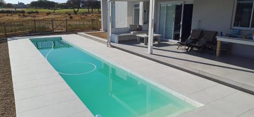Kolam renang di atau dekat dengan HIDDEN GEM A unique Golf Estate and Game Reserve north facing 6 sleeper 3 en suite bedrooms with 12m Solar Warmed Lap Pool