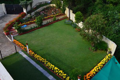 an overhead view of a garden with flowers and benches at Serenity Manor in Coonoor