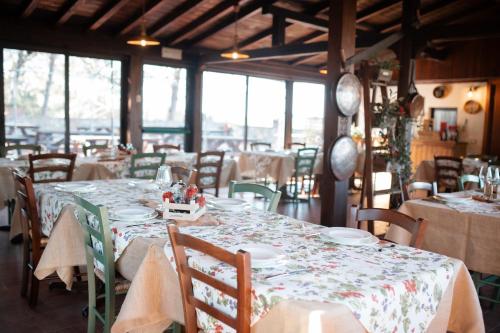a dining room with a table and chairs with white table cloth at Borgo Il Poggio Agriturismo in Montaione
