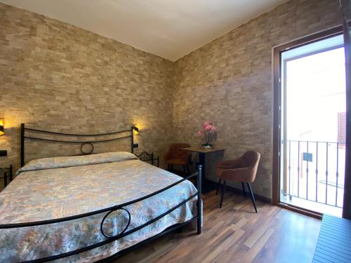 a bedroom with a bed and a large window at Uria Rooms & Suite B&B in Vieste