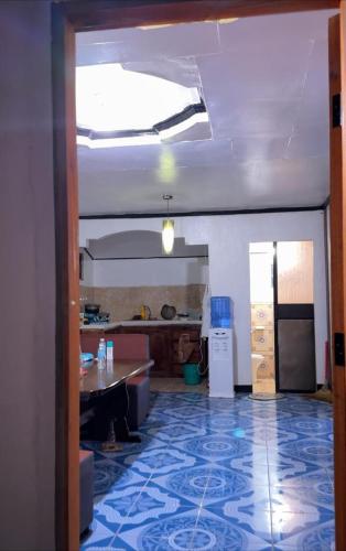 a room with a kitchen and a living room at Emmasguesthouse in Paracale