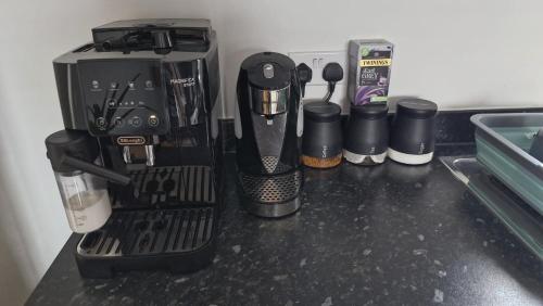 a kitchen counter with a coffee maker and other appliances at The Lancers in Kent