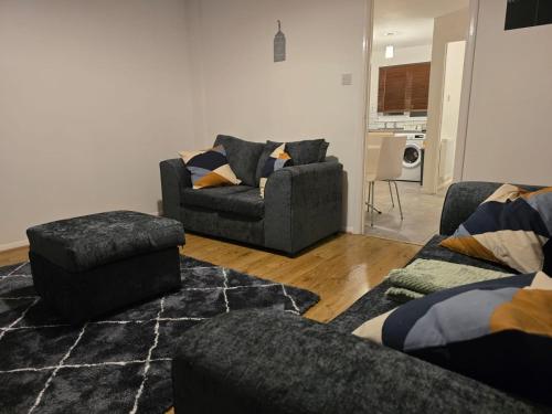 a living room with two couches and a couch at Stylish 3 bedrooms in Bradwell