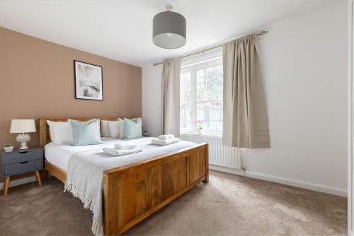a bedroom with a large bed and a window at The Clapham Terraced House in London