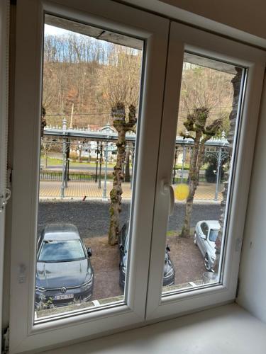 a window with a view of a car parked outside at Gîte "Au Fourneau" in Spa