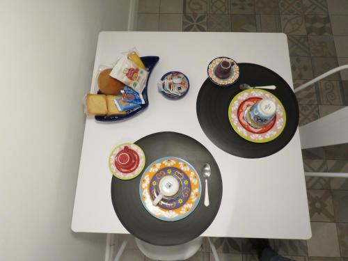 a white table with plates and bowls on it at Apulia 35 in Bari