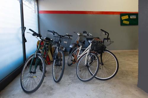 three bikes parked next to each other in a room at Hotel Jane in Florence