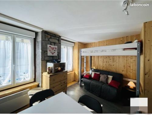 - une chambre avec des lits superposés et un canapé dans l'établissement Studio au cœur du centre ville, à Le Mont-Dore