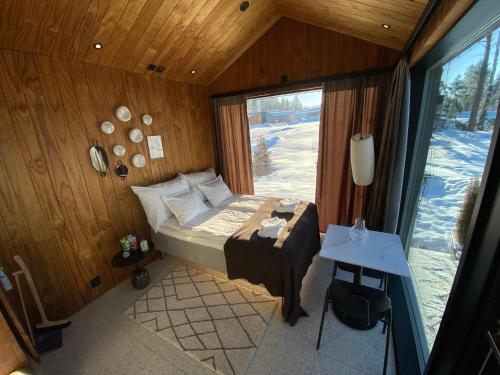 a bedroom with a bed in a room with a window at Guesthouse with sauna & hot tub & cold water pool in Nokia