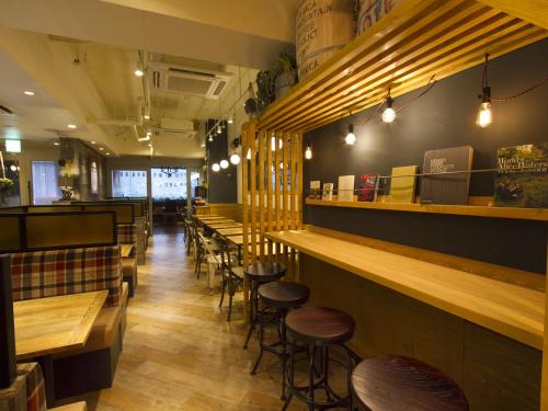 a row of tables and stools in a restaurant at APA Hotel Mito-eki Kita in Mito