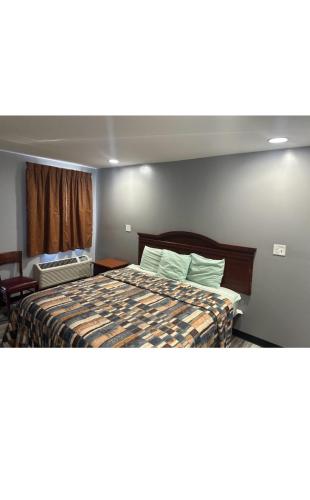 a hotel room with a bed and a window at Sky Inn Hotel in Birmingham