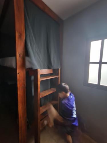 a child sitting on the bottom bunk of a bunk bed at Salta eco alojamiento in Salta