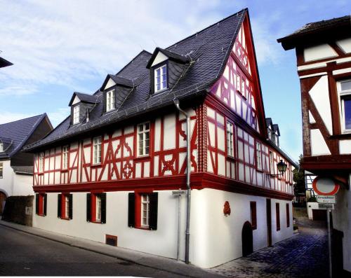 a red and white building with a black roof at Weinhotel Eltvinum in Eltville