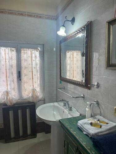 a bathroom with a sink and a mirror at Villa Chiara B&B in Civitavecchia