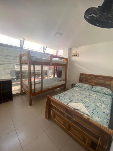 a bedroom with two bunk beds and a window at HOTEL MI RANCHITO in Sincelejo