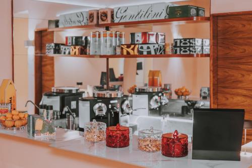 a coffee shop with coffee machines on a counter at Albergo Delle Regioni, Barberini - Fontana di Trevi in Rome