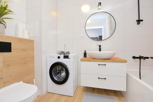 a bathroom with a washing machine and a sink at SuperApart Prymasa 1000-lecia 6a, Hidden Gem - Ideal for Relaxation & Escapes in Rzeszów