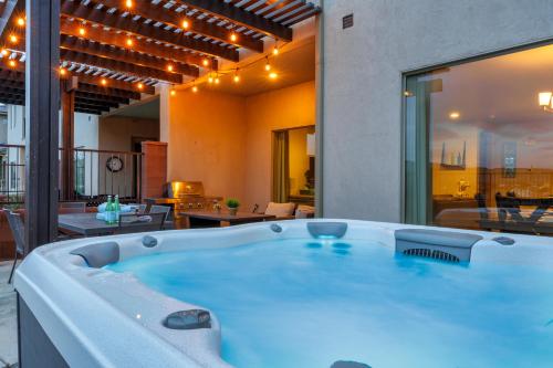 a large bath tub in a room with a patio at Savannah's Zion Retreat-NEW PRIVATE HOT TUB in Hurricane