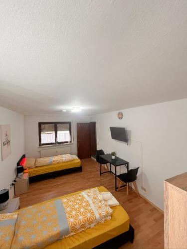 a room with two beds and a desk in it at Herrenalber in Bad Herrenalb