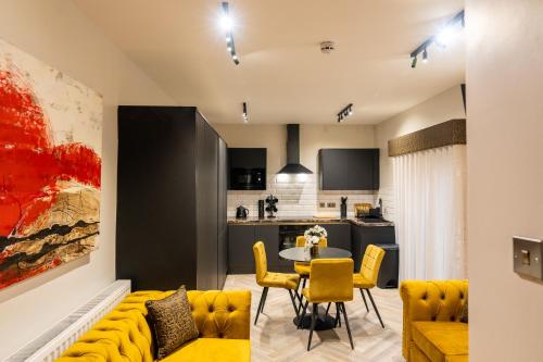 a living room with a yellow couch and a table at Home @ Arkles Lane in Liverpool