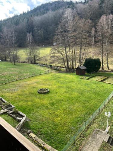 a large field of grass with trees and a fence at Herrenalber in Bad Herrenalb
