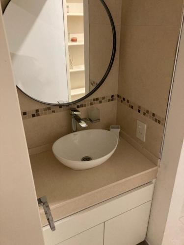 a bathroom with a sink and a mirror at Casa en General Rodríguez. in General Rodríguez