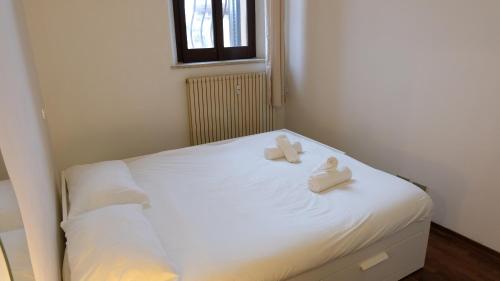 a white bed with two towels on top of it at Mazzini 81 - Ravenna Apartments in Ravenna