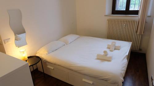 a bedroom with a bed with two candles on it at Mazzini 81 - Ravenna Apartments in Ravenna
