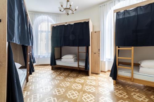 a bedroom with two bunk beds and a chandelier at Soborniy Hostel in Lviv