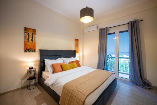 a bedroom with a bed and a large window at Central 2 Bdrm Aprt In Koukaki! in Athens