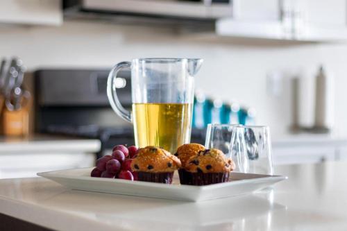 a plate of muffins and a glass of beer on a counter at Discover Zion Mountain, Private Hot Tub-3 Bedroom in Hurricane